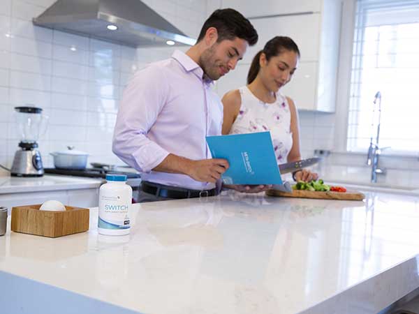 Couple cooking dinner using the Max Flex Food Guide