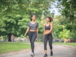 Image of two women walking in the park