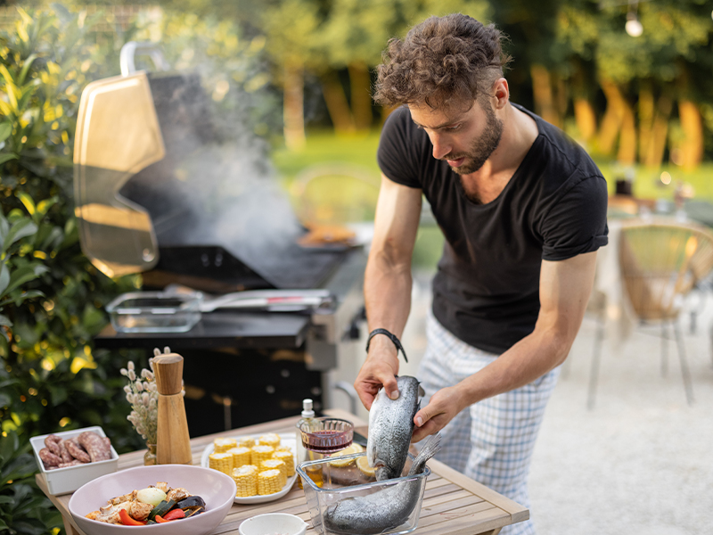 Image of man grilling fish