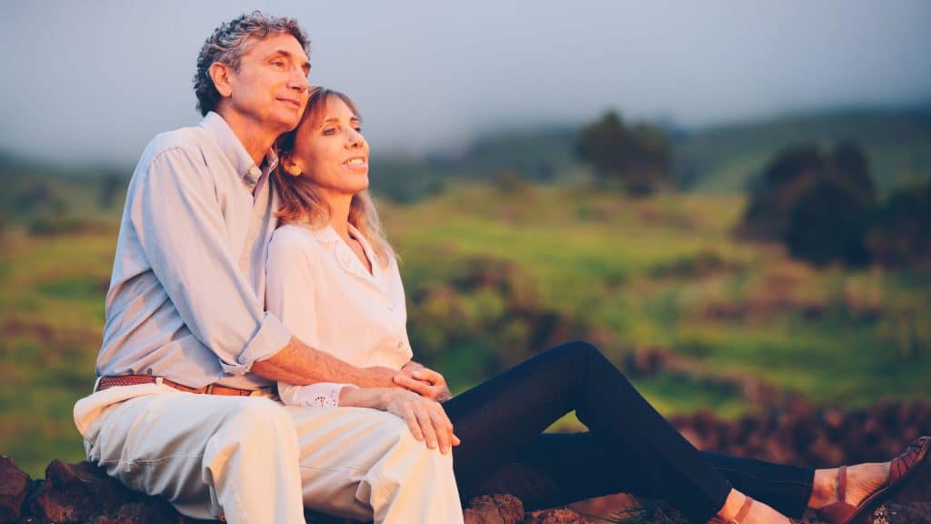 Image of an older male with his wife enjoying a sunset