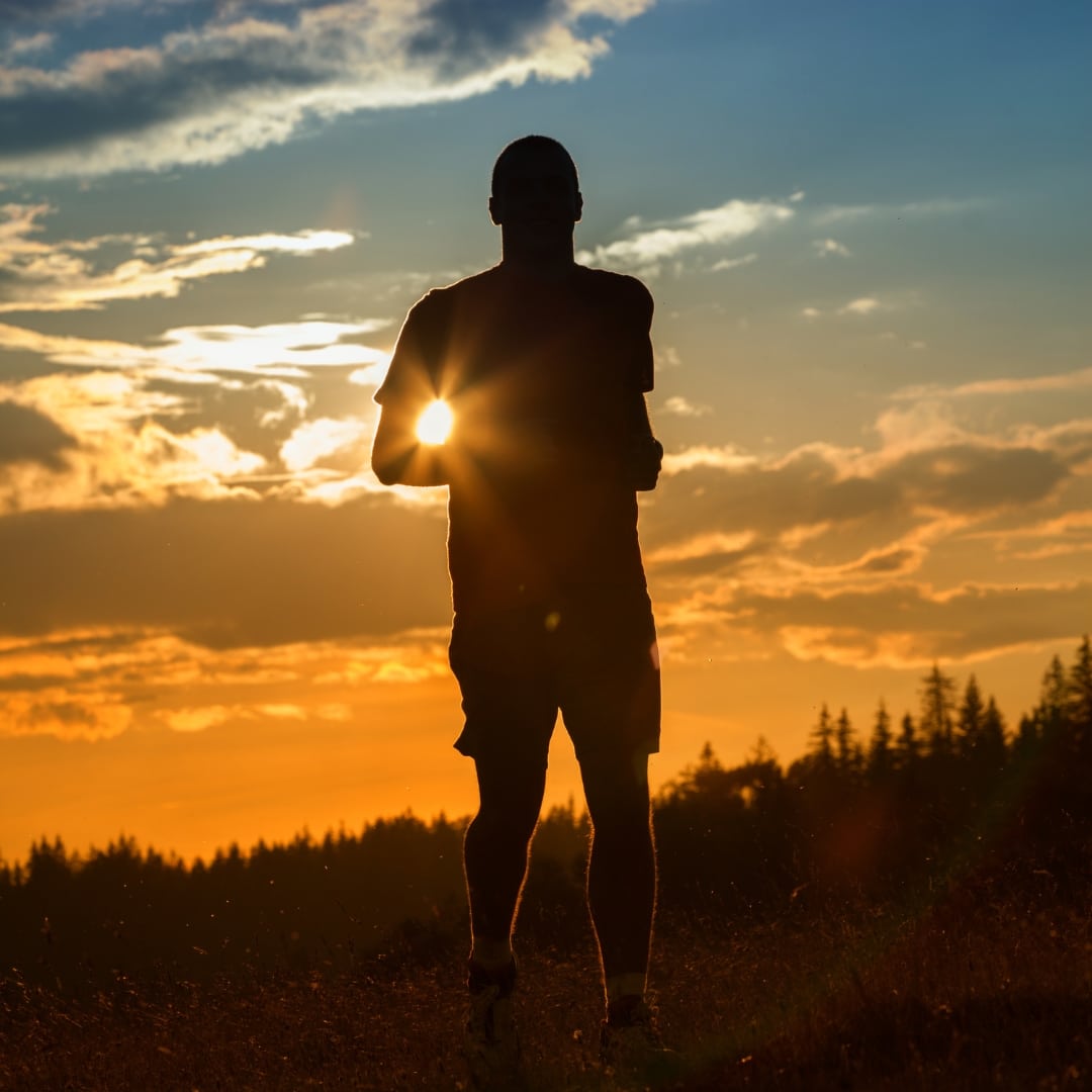Image of a man jogging at sunset