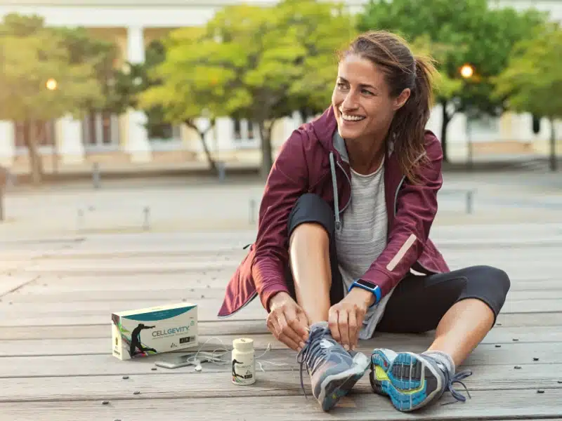 Image of a woman next to a bottle of Cellgevity